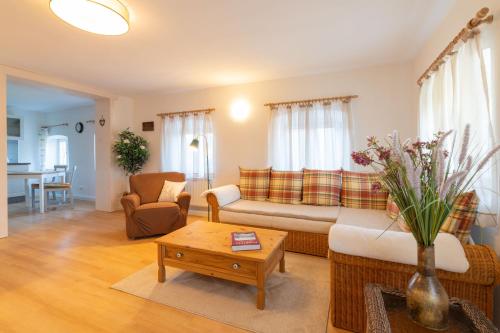 a living room with a couch and a table at Huberhof Meisham in Eggstätt