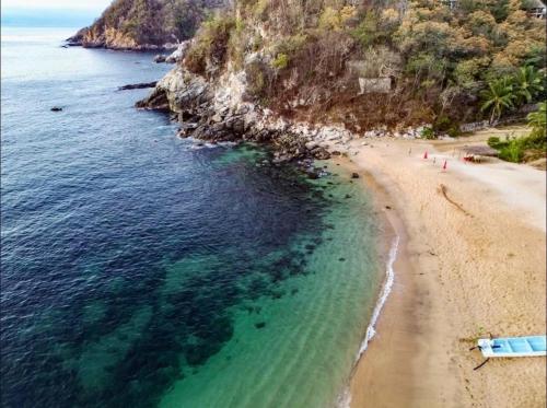an aerial view of a beach and the ocean at Habitaciones en casa De los árboles en la playa con alberca in Arroyo Cruz
