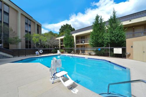 a swimming pool in front of a building at Wyndham Garden Marietta Atlanta North in Marietta