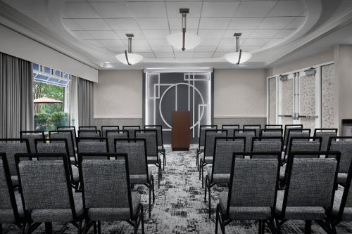 an empty room with rows of chairs and a door at Hotel Indigo Jacksonville-Deerwood Park by IHG in Jacksonville