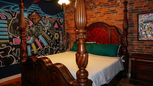 a bedroom with a wooden bed in a brick wall at Broadway Penthouse 4br 3bth 2500 SF in Nashville