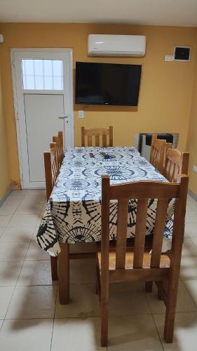 a dining room table with a blue and white table cloth at Kaike in Caleta Olivia