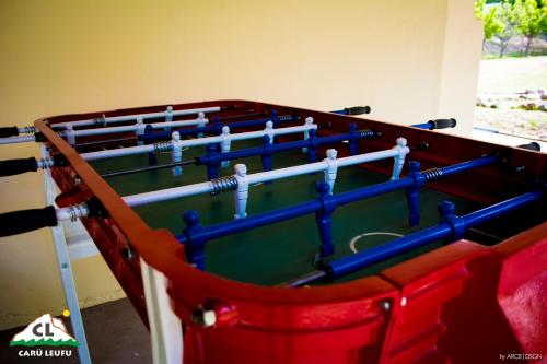a pool table with blue bars on top of it at Carü Leufu in Valle Grande