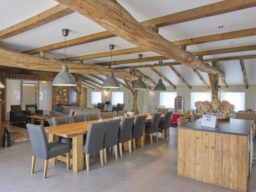 a dining room with a large wooden table and chairs at Bouwhoeve in Elsendorp
