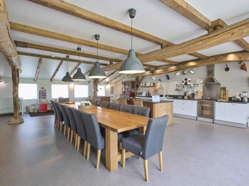 a kitchen and dining room with a wooden table and chairs at Bouwhoeve in Elsendorp