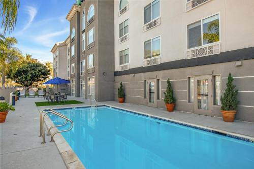 a swimming pool in front of a building at Holiday Inn Express San Diego - Sorrento Valley by IHG in Sorrento