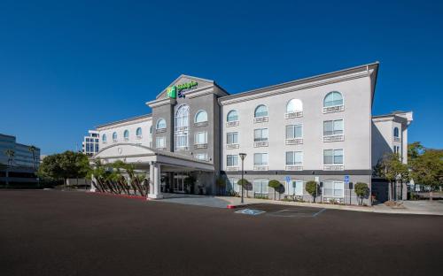 a large white building on a street at Holiday Inn Express San Diego - Sorrento Valley by IHG in Sorrento