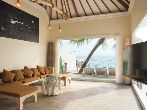 a living room with a view of the ocean at Amada Penida Villa in Nusa Penida