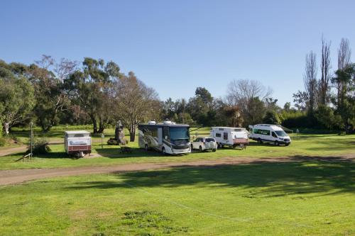 a group of vehicles parked in a park at Poplar Tourist Park in Camden