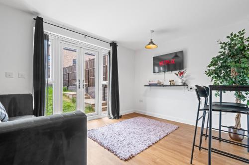 a living room with a couch and a window at Lotus Haus - Wellington Homes - 4 BDR With Gated Parking in Birmingham