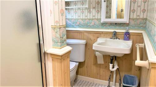 a small bathroom with a toilet and a sink at Little Sandpiper in Cape May Point