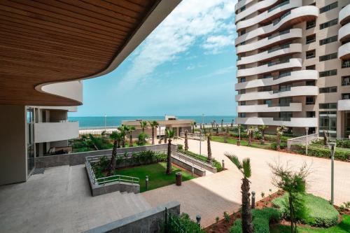 a view of the beach from the balcony of a building at Magnifique appartement pleine vue mer Marina Casablanca in Casablanca