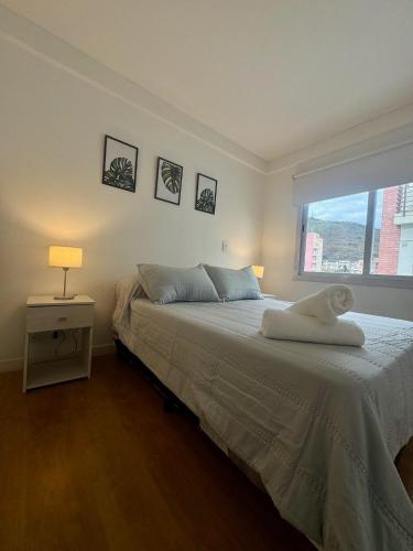a bedroom with a bed with a towel on it at Augusto Apart 3 in Salta