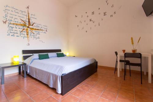 a bedroom with a bed and a wall with writing on the wall at Villa Mondello in Mondello