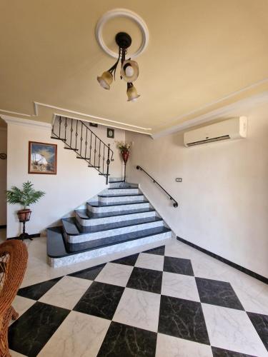 a room with a staircase with a checkerboard floor at Villa los Dulces-Piscina Privada in Letur