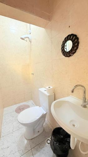 a bathroom with a white toilet and a sink at Hotel Tenda São Bernardo do Campo in São Bernardo do Campo