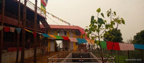 a building with colorful flags hanging from it at Everest Home Stay Temal Kalimati Tower in Thapathali