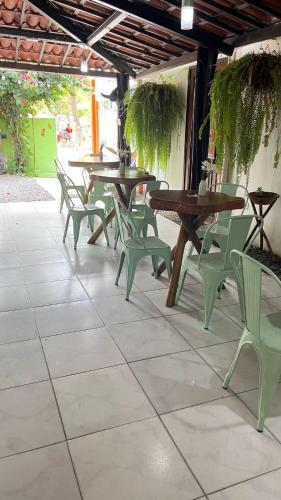a group of tables and chairs on a patio at Pousada Porto de Amigos in Porto De Galinhas