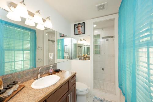 a bathroom with a sink and a toilet and a shower at Heron Hideaway in Key West