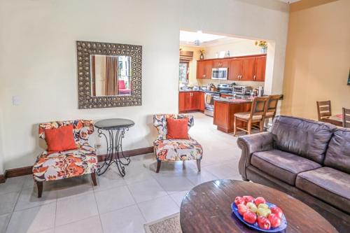a living room with a couch and a table at Macaws Ocean Club Apartamento # 18 in Jacó