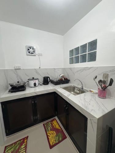 a kitchen with a sink and a counter top at Casa Celine Dumaguete in Dumaguete