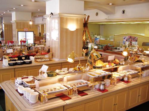 a buffet line with food on display in a restaurant at Kagoshima Sun Royal Hotel in Kagoshima