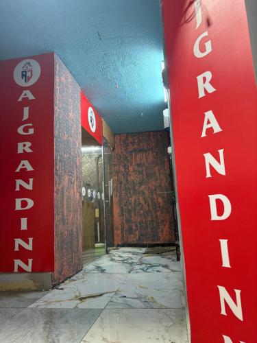 an empty room with a red sign on the wall at AJ GrandInn in Podanūr