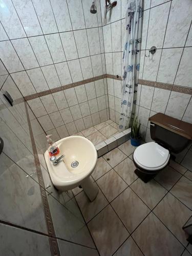 a bathroom with a sink and a toilet at Orkkowasi backpackers in Arequipa