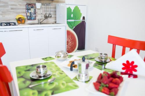 a kitchen table with a plate of fruit on it at Baia Del Sole in Licata