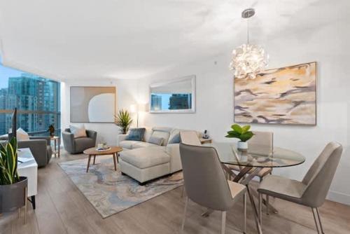 a living room with a couch and a table at Executive Downtown Suite with Great City Views in Vancouver