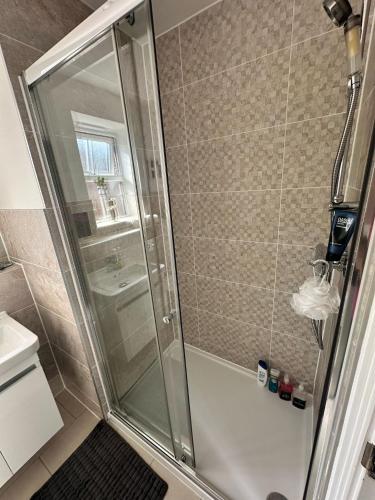 a shower with a glass door in a bathroom at Premium Living Space in Rugby in Rugby