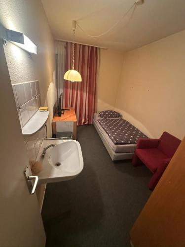 a bathroom with a sink and a bed in a room at Turp Residenz in Blomberg