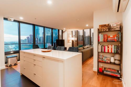 a kitchen and living room with a view of the city at Skyline Escape I Chic City Stay & Free Parking in Melbourne