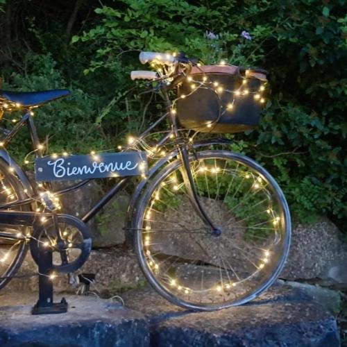 a bike with lights on the front of it at Le nid du canal in Pezens