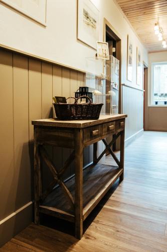 a wooden table in a hallway with a counter at B&B A L'aise in Durbuy
