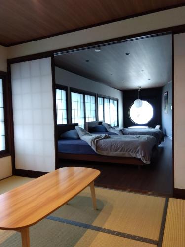 a bedroom with a bed and a large mirror at Daihachi in Takayama
