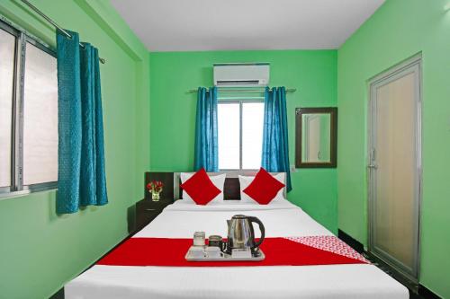 1 dormitorio con 1 cama con paredes verdes en Hotel O Hotel Acronis, en Calcuta