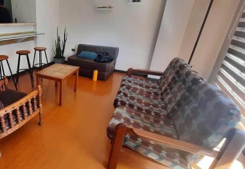 Departamento في كوتشابامبا: غرفة معيشة بها أريكة وطاولة