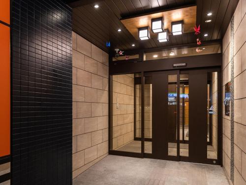 a hallway of a building with glass doors at APA Hotel Nambaminami Daikokucho Ekimae in Osaka