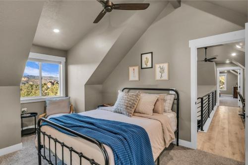 a bedroom with a bed and a ceiling fan at Cactus Canyon Retreat Zion Base Hot Tub View in Orderville