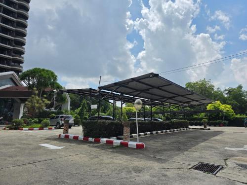 a parking lot with a black canopy in a parking lot at First Pacific Cirrus in Pattaya Central