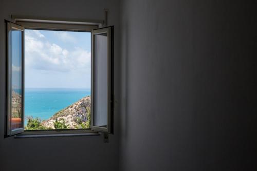 a window with a view of the ocean at Baia Del Sole in Licata