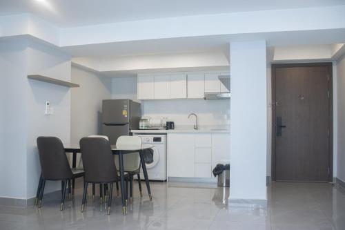 a kitchen with a table and chairs in a room at Parc21 Luxury Boutique Hotel in Phnom Penh