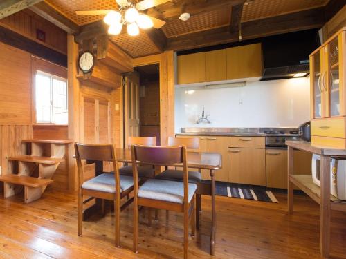 a kitchen with a table and chairs in a room at Sun Green Resort Hotel Ishigaki in Ishigaki Island