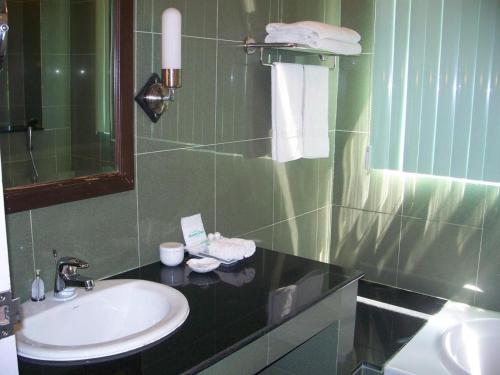 a bathroom with a sink and a mirror at Kasem Garden Hotel Surin in Surin