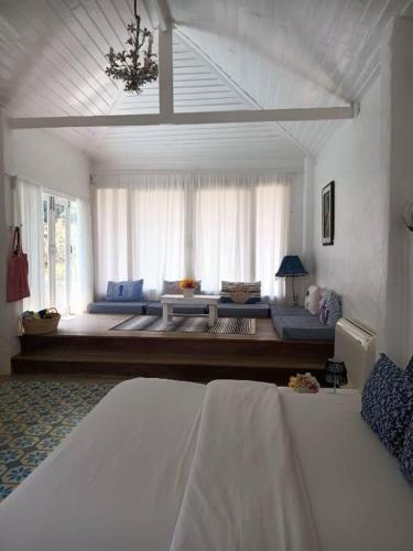 a bedroom with a bed and a large window at Brassiere Beach Hotel in Baanphakrimlay 