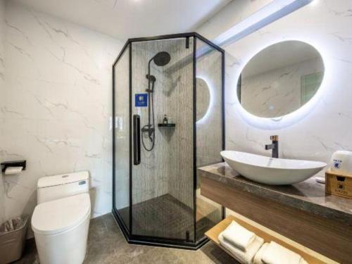 a bathroom with a shower and a sink and a toilet at Super 8 Hotel Xiamen Railway Station in Xiamen
