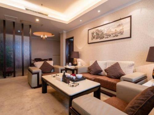 a living room with a couch and a table at Quanzhou Royal Prince Hotel in Quanzhou