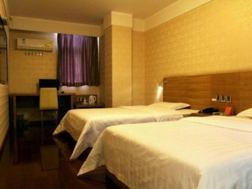 a hotel room with two beds and a window at 7 Days Inn Nanjing Gaochun Metro Station in Gaochun