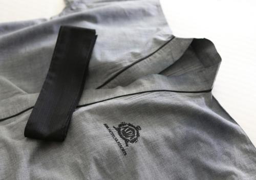 a black tie sitting on top of a gray shirt at APA Hotel Kanda Jimbocho Ekihigashi in Tokyo